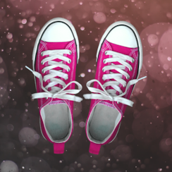 Pink Converse sneakers on sparkly background